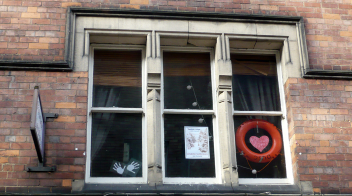 Personalising space is a universal hobby. Even when we are temporary residents, for example, students renting a flat for a year, we find reversible means of making our space represent us. The poster on this second storey window is almost impossible to read from the street - but it means something to somebody, and so up it went. (Incidentally, it is a poster for a Hatfield College ball). The red life-saver probably represents Durham University Swimming Club.